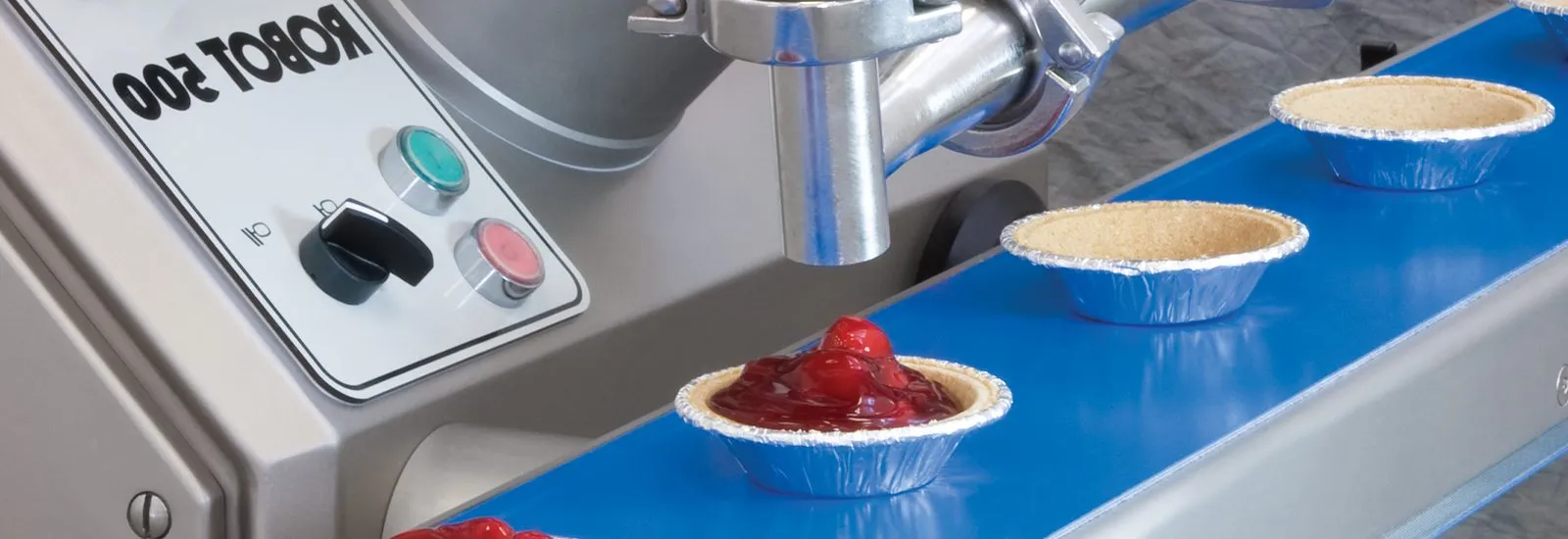 Pie shells being filled by a VEMAG depositor