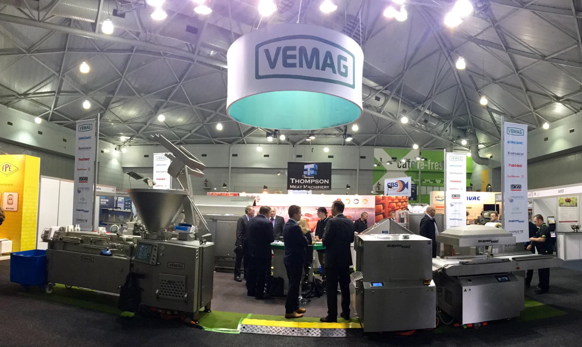 Hanging VEMAG drum sign above the stand with visitors