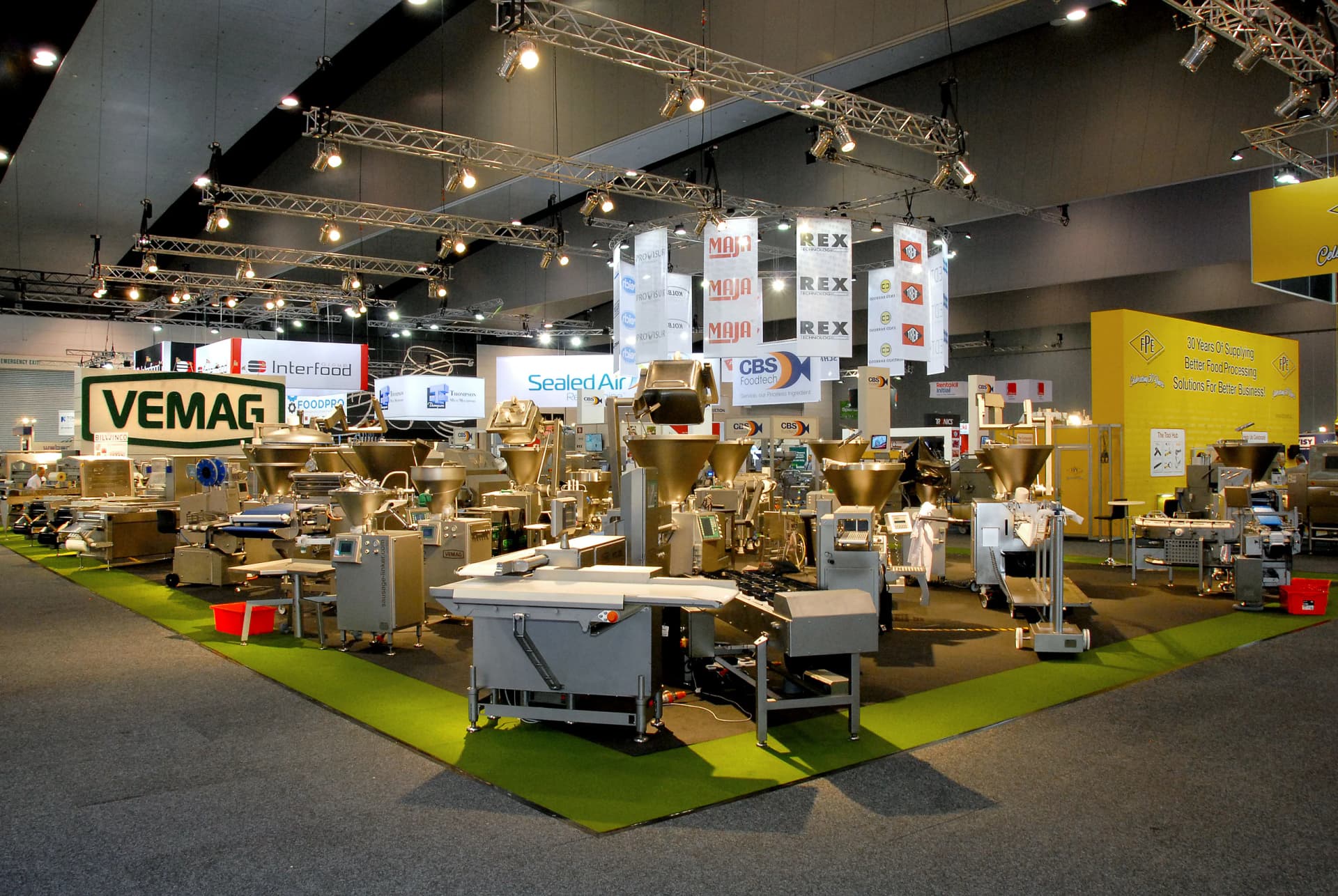 Wide view of a VEMAG exhibition stand with machinery