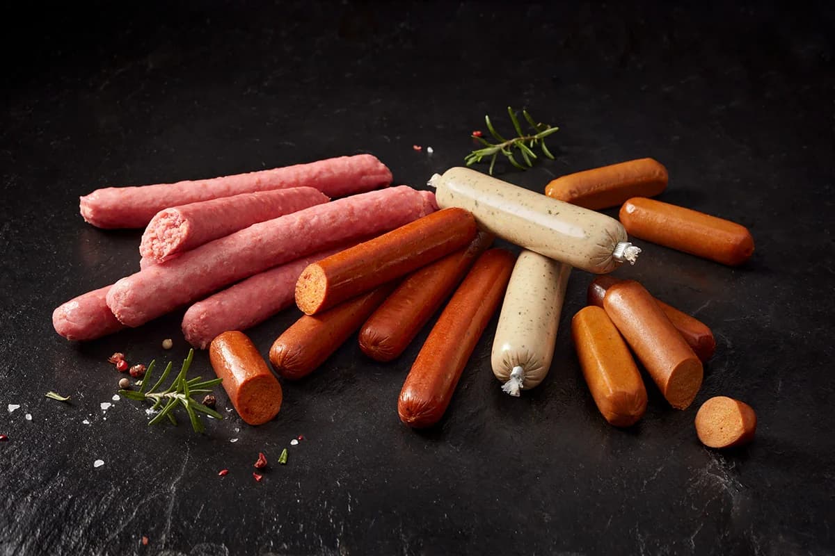 Plant-based sausages on a dark surface