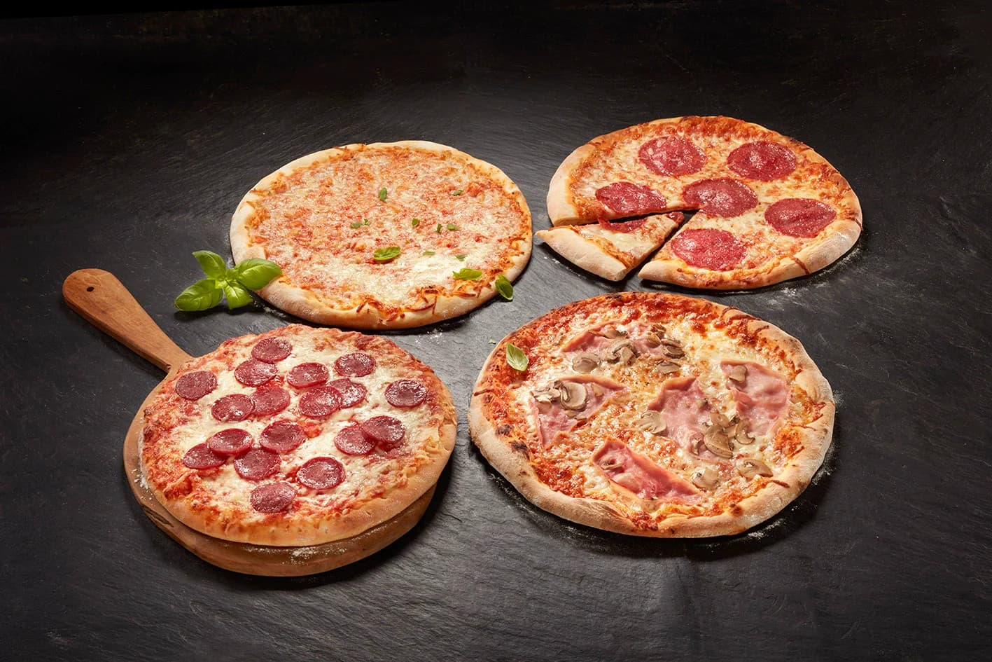 Pizzas on a dark surface