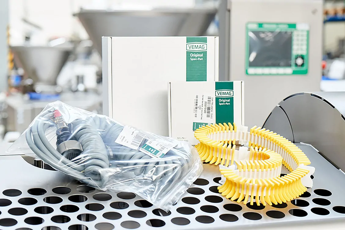 Spare parts laid out on a hole plate in front of machinery
